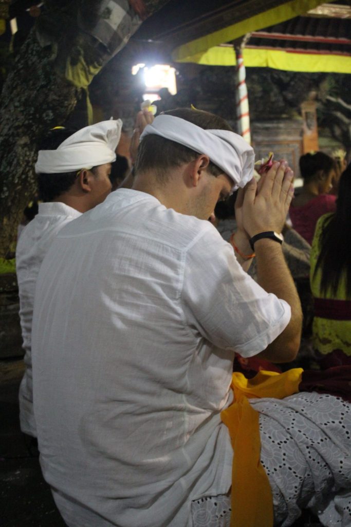 full moon ceremony bali praying flowers